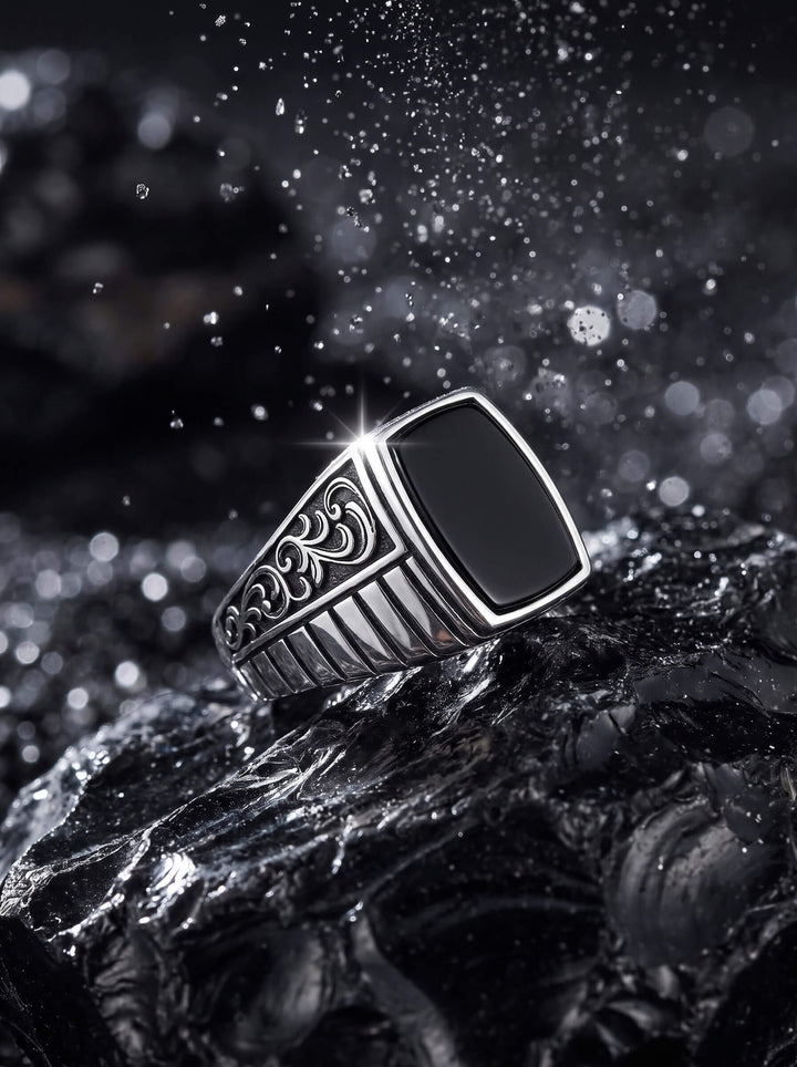 Silver Shadow Ring with a sleek black rectangular stone and ornate silver detailing displayed on dark textured rock with water droplets Up To 75% Off Retail