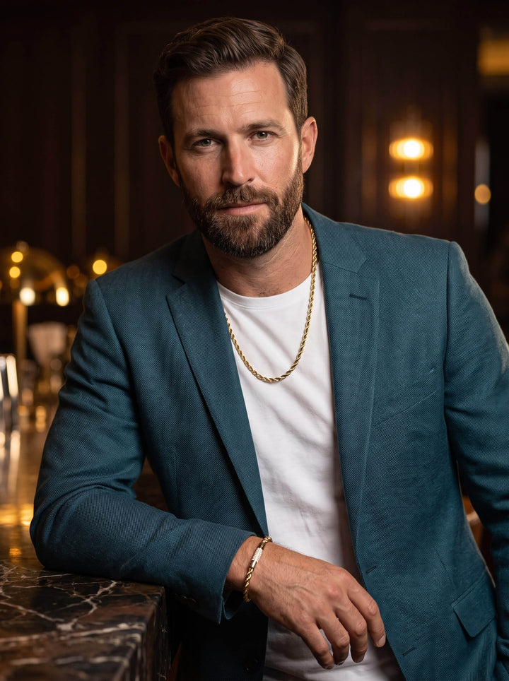 Viper Twist Rope Necklace in gold worn by a bearded man in a teal blazer over a white shirt with warm evening lighting Up To 75% Off Retail