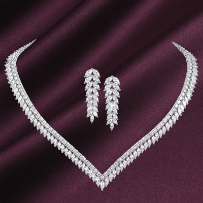 Crystal Cascade Collection featuring a sparkling crystal necklace and matching drop earrings displayed on rich burgundy fabric Up To 75% Off Retail