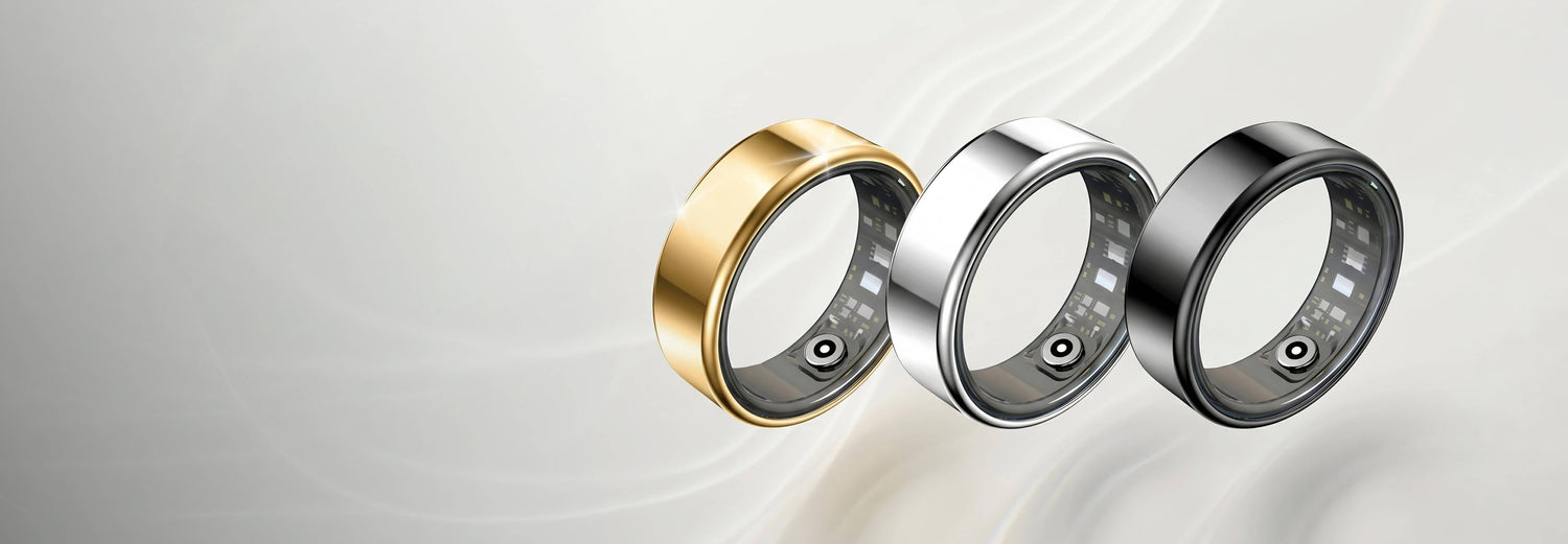 Three metallic rings in gold, silver, and gray on a light gray background