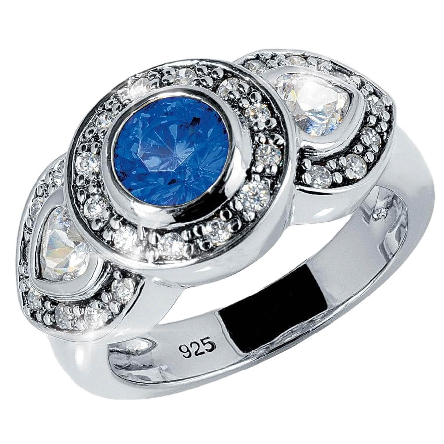 Maharajah Blue Ring featuring a sterling silver band plated in rhodium with a central blue gemstone surrounded by sparkling clear stones, designed for women’s jewelry.