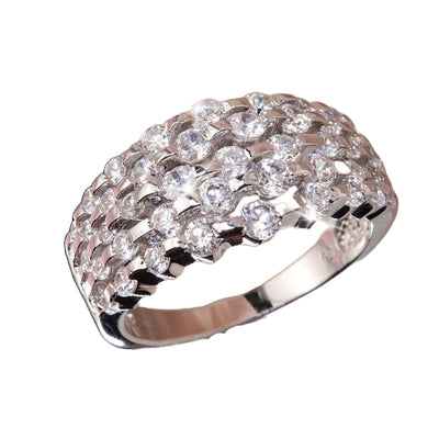 Amelia Ring featuring a sterling silver band with rhodium plating, adorned with multiple sparkling stones, designed for women’s jewelry collections.