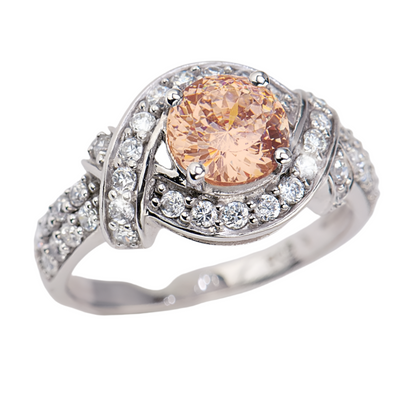 Lover's Knot Mandarin Ring featuring a sterling silver band with rhodium plating, adorned with a central mandarin-colored gemstone surrounded by sparkling clear stones.