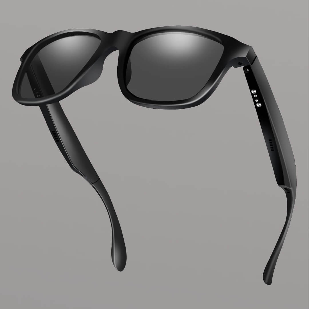 Black smart sunglasses with reflective lenses on a gray background