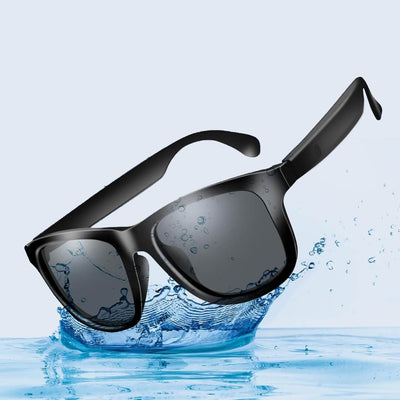 Black smart sunglasses with water droplets on a blue water background