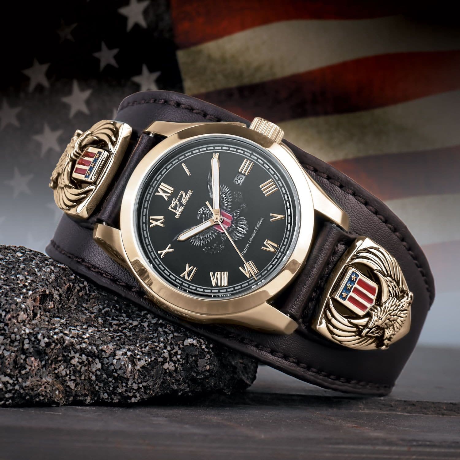 Patriot Men's Watch with gold plating, black dial, and stainless steel case, featuring a wide brown leather band decorated with American eagle and shield emblems, set against a blurred American flag background.