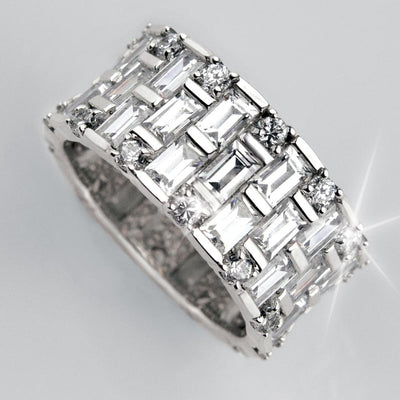 Baguette Eternity Ring featuring sterling silver with rhodium plating, adorned with a continuous row of rectangular and round clear stones, designed for female jewelry enthusiasts.