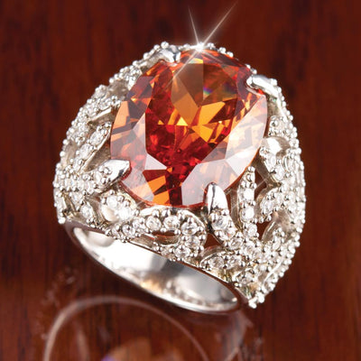 Fire Cocktail Ring featuring a large fiery orange gemstone set in a sterling silver band with intricate rhodium-plated detailing, designed for women’s jewelry collections.