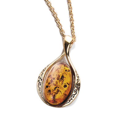 Baltic Amber Pendant featuring a polished amber stone set in sterling silver with gold plating, designed for female jewelry collection.