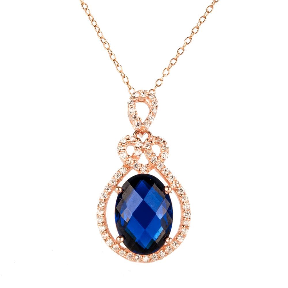 Rosa De Mer Pendant featuring a deep blue faceted stone surrounded by rose gold plated sterling silver with sparkling accents, designed for women’s jewelry collections.