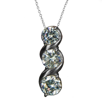 Solitaire Twist Pendant featuring three sparkling round stones set in sterling silver with rhodium plating, designed for women, on a delicate chain necklace.