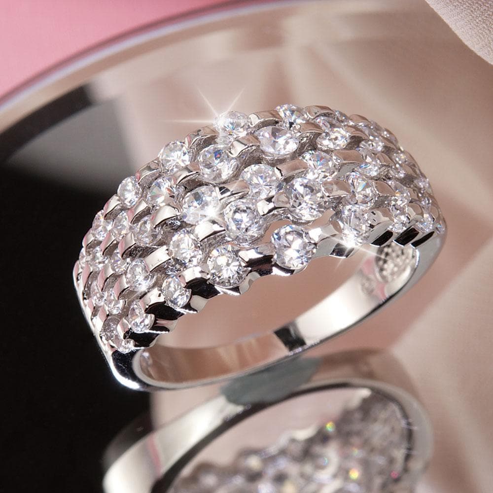 Amelia Ring featuring a sterling silver band with rhodium plating, adorned with multiple sparkling stones, designed for women’s elegant jewelry collections.