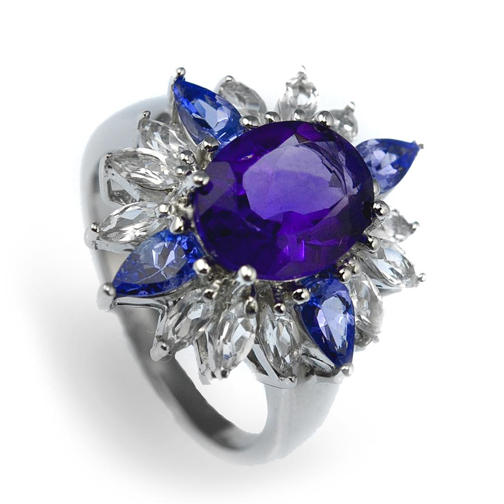 Super Nova Ring featuring a sterling silver band with rhodium plating, adorned with a large purple central gemstone surrounded by alternating blue and clear stones, designed for women’s jewelry.