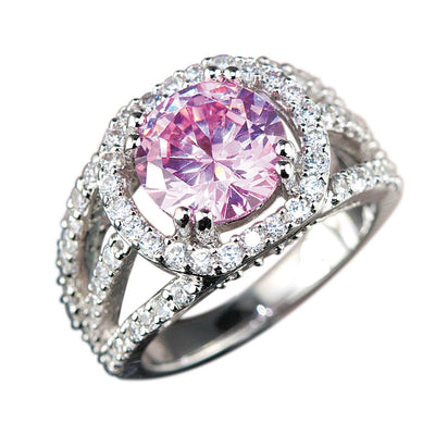 Blush Halo Ring featuring a sparkling pink center stone surrounded by a rhodium-plated sterling silver band encrusted with small dazzling crystals, designed for women’s jewelry.