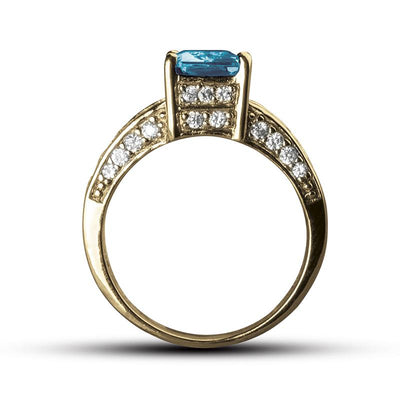 Sonora Dress Ring featuring a sterling silver band with a rectangular blue gemstone centerpiece and surrounded by small sparkling stones, designed for women’s jewelry.