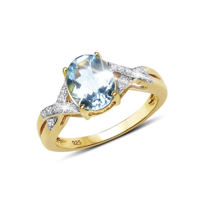 Majorelle Blue Topaz Ring featuring a gold plated sterling silver band with sparkling accent stones surrounding an oval blue topaz centerpiece, designed for women’s jewelry.