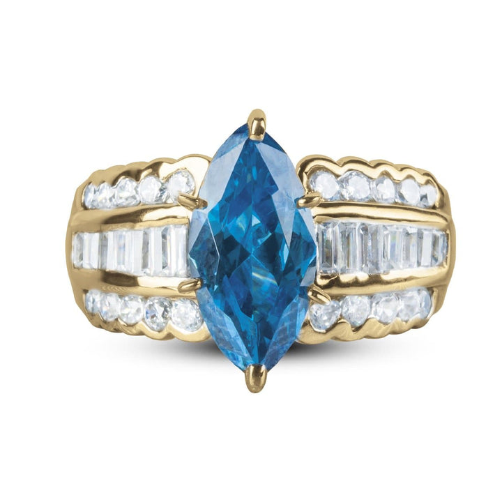 Carman Marquise Ring featuring a gold-plated stainless steel band with a large blue marquise-cut center stone and rows of clear accent stones on each side, designed for women.