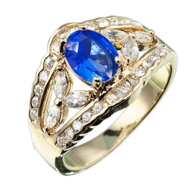 Regency Sapphire Ring featuring a gold-plated sterling silver band with a large oval sapphire center stone surrounded by sparkling clear stones, designed for women’s jewelry.