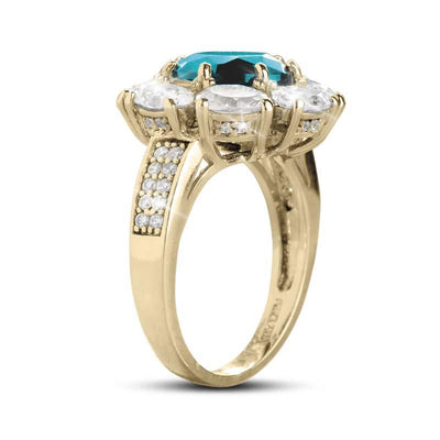 Glacial Cluster Ring in sterling silver with gold plating, featuring a large blue center stone surrounded by smaller clear stones, designed for women’s jewelry collections.