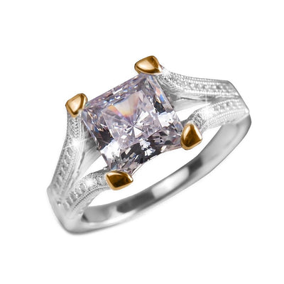 Princessa Ring featuring a two-tone sterling silver band with intricate detailing and a large square-cut clear gemstone, designed for women’s jewelry collections.