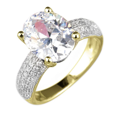 Caravella Gold Ring featuring a large oval clear stone set in sterling silver with gold accents and a band encrusted with small sparkling stones, designed for women.
