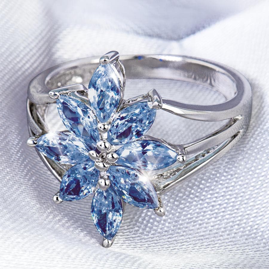 Tanzanite Flower Ring featuring a sterling silver band with rhodium plating, designed for females, showcasing a delicate flower shape crafted from marquise-cut tanzanite gemstones.