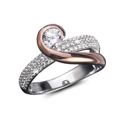 Emelia Ring featuring a two-tone sterling silver design with a swirl pattern, a central sparkling gemstone, and pavé-set smaller stones for an elegant female jewelry piece.