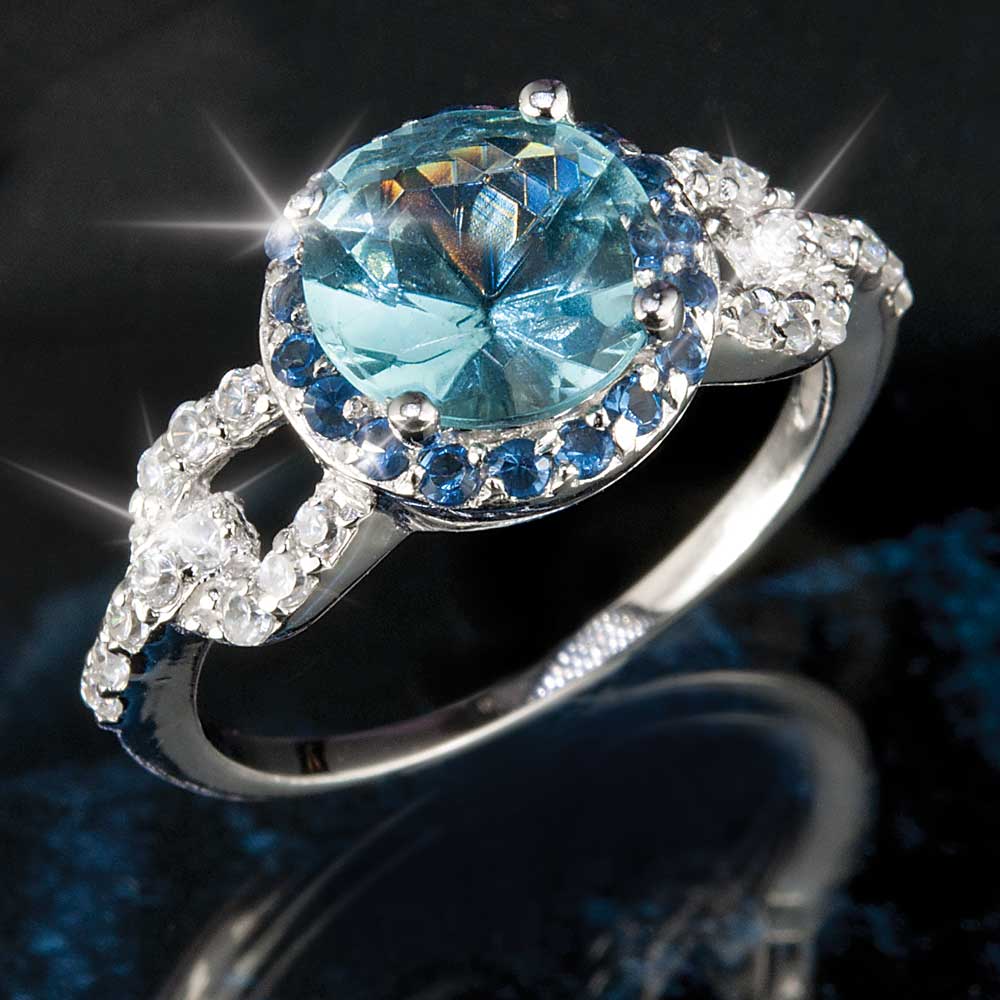 Valetta Ring featuring a sterling silver band with a large central blue gemstone surrounded by smaller dark blue and clear stones, designed for female jewelry collectors.