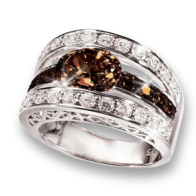 Verona Chocolate Ring featuring a sterling silver band with rhodium plating, adorned with a central chocolate-colored gemstone and sparkling clear stones for an elegant female jewelry piece.